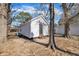Charming backyard featuring a white cottage-style home and mature trees at 210 Circle Dr, Smithfield, NC 27577