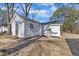 Exterior view of the home, featuring a simple backyard with mature trees and minimal landscaping at 210 Circle Dr, Smithfield, NC 27577
