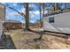 The backyard shows mature trees, partial fence and part of the home's siding at 210 Circle Dr, Smithfield, NC 27577