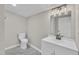 Bathroom featuring white vanity, modern light fixture, and neutral wall and floor at 210 Circle Dr, Smithfield, NC 27577