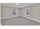 Bedroom with gray carpet, fresh paint, and a large window providing ample natural light at 210 Circle Dr, Smithfield, NC 27577