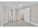 Bedroom featuring a light gray carpet, closet and doorway, and neutral wall paneling at 210 Circle Dr, Smithfield, NC 27577