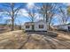 Attractive single-Gathering home featuring a charming front yard with mature trees and lush landscaping at 210 Circle Dr, Smithfield, NC 27577