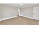 An open living room featuring wood-look flooring and freshly painted walls leading to other areas of the home at 210 Circle Dr, Smithfield, NC 27577