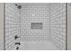 Modern shower with white subway tile, matte black fixture, and built-in shelving for toiletries at 210 Circle Dr, Smithfield, NC 27577