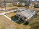 High angle view of a home featuring a metal roof, covered porch, and a long paved driveway at 231 Patterson Dr, Roxboro, NC 27573
