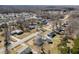 This aerial view shows the neighborhood's roads and the surrounding trees at 231 Patterson Dr, Roxboro, NC 27573