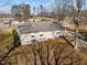 A view of the rear of the home showing the roofline, a yard, and neighborhood at 231 Patterson Dr, Roxboro, NC 27573