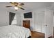 This bedroom boasts a ceiling fan, TV, closet, and hardwood floors at 231 Patterson Dr, Roxboro, NC 27573