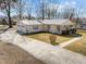 Charming ranch-style home with a metal roof, a covered front porch, and an attached two-car garage at 231 Patterson Dr, Roxboro, NC 27573