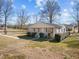 Single-story home with porch and well-kept hedges, and easy access walkway at 231 Patterson Dr, Roxboro, NC 27573