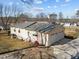A view of the side and rear of the home showing a metal roof, a driveway, and a yard at 231 Patterson Dr, Roxboro, NC 27573