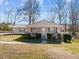 Quaint single-story home with a cozy porch, metal roof, and well-manicured lawn at 231 Patterson Dr, Roxboro, NC 27573