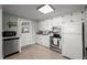 Well-maintained kitchen with white cabinets, stainless steel appliances, and ample counter space at 231 Patterson Dr, Roxboro, NC 27573