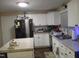 Bright kitchen features white cabinets, stainless steel appliances, and a center island at 2506 Poole Rd, Raleigh, NC 27610