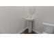 Powder room featuring a sleek pedestal sink, mirror, and modern toilet at 2561 Summersby Dr, Mebane, NC 27302