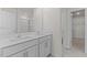Bright bathroom featuring a double sink vanity, large mirror, and modern fixtures at 2561 Summersby Dr, Mebane, NC 27302