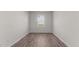 Empty room with hard wood floors and a window offering plenty of sunlight at 2561 Summersby Dr, Mebane, NC 27302