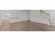 Open-concept living area with hardwood floors and access to other parts of the home at 2561 Summersby Dr, Mebane, NC 27302