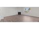 Bright living room featuring hardwood floors, a fireplace, and a large window at 2561 Summersby Dr, Mebane, NC 27302