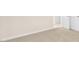 Carpeted neutral bedroom featuring a white door and trim, with a large window, creating a peaceful and inviting atmosphere at 262 Palm Dr, Sanford, NC 27332