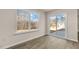 Living room with large windows, wood flooring, and sliding glass door to back patio at 262 Palm Dr, Sanford, NC 27332