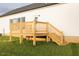 New wooden deck and stairs lead to a level, grassy yard at 29 Hinshaw Shop Rd, Liberty, NC 27298