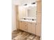 Bathroom vanity features double sinks, wood cabinets, modern fixtures, and wood-look flooring at 29 Hinshaw Shop Rd, Liberty, NC 27298