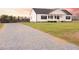 Gravel driveway leading to a charming home with a covered porch and lovely landscaping at 29 Hinshaw Shop Rd, Liberty, NC 27298