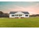 Charming single-story home featuring a welcoming front porch and classic black shutters at 29 Hinshaw Shop Rd, Liberty, NC 27298