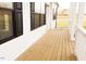 Charming side porch with stained wooden floorboards and classic white railing at 29 Hinshaw Shop Rd, Liberty, NC 27298