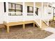 Classic front porch featuring white railings and stained wooden floorboards at 29 Hinshaw Shop Rd, Liberty, NC 27298