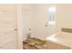 Laundry room features sink, wood-look floors, washer hookups and white cabinets at 29 Hinshaw Shop Rd, Liberty, NC 27298