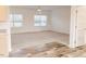 Bright living room featuring plush carpeting, large windows, and neutral wall colors at 29 Hinshaw Shop Rd, Liberty, NC 27298