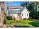Well-maintained backyard features lush grass, mature trees, and a charming deck, perfect for outdoor entertaining at 2909 Hawtree Dr, Raleigh, NC 27613