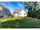 Spacious backyard with a well-kept lawn, mature trees, and a deck, creating an inviting outdoor space at 2909 Hawtree Dr, Raleigh, NC 27613