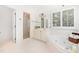 Bright bathroom with a soaking tub, a tiled shower, a vanity, and plantation shutters at 2909 Hawtree Dr, Raleigh, NC 27613