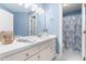Bathroom vanity with a framed mirror and a shower-tub combo at 2909 Hawtree Dr, Raleigh, NC 27613