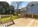 Spacious wooden deck offers serene views of the lush green lawn and mature trees at 2909 Hawtree Dr, Raleigh, NC 27613