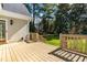 Wooden deck with railing overlooks a grassy yard and mature trees, adding to the home's outdoor appeal at 2909 Hawtree Dr, Raleigh, NC 27613