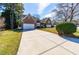 Long driveway leads to this brick home with an attached garage and beautiful landscaping at 2909 Hawtree Dr, Raleigh, NC 27613