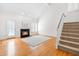 Sunlit living room boasts a fireplace, staircase, and access to the backyard, with hardwood floors at 2909 Hawtree Dr, Raleigh, NC 27613