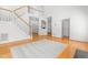 Open-concept living area featuring a staircase, hardwood floors, and ample natural light at 2909 Hawtree Dr, Raleigh, NC 27613