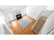 Open-concept living room featuring hardwood floors, a fireplace, and a staircase at 2909 Hawtree Dr, Raleigh, NC 27613