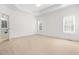 Spacious main bedroom boasts tray ceilings, carpet, and bright windows at 2909 Hawtree Dr, Raleigh, NC 27613
