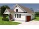 New construction shows a charming two-story home with a landscaped yard and attached garage at 2966 Forest Creek Ln, Mebane, NC 27302
