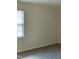A simple bedroom with neutral walls, carpet, and a window that allows for natural light to brighten the room at 309 Gladstone Dr, Durham, NC 27703