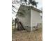 Side of home featuring neutral vinyl siding, gray brick foundation, wooden steps, and a gas utility meter at 309 Gladstone Dr, Durham, NC 27703