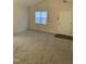 Bright and airy living room featuring neutral carpet, vaulted ceiling, and a large window with blinds for natural light at 309 Gladstone Dr, Durham, NC 27703