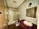 Bathroom features a shower/tub combination, toilet, and vanity with a unique wallpaper design at 328 Cone Dr, Henderson, NC 27537